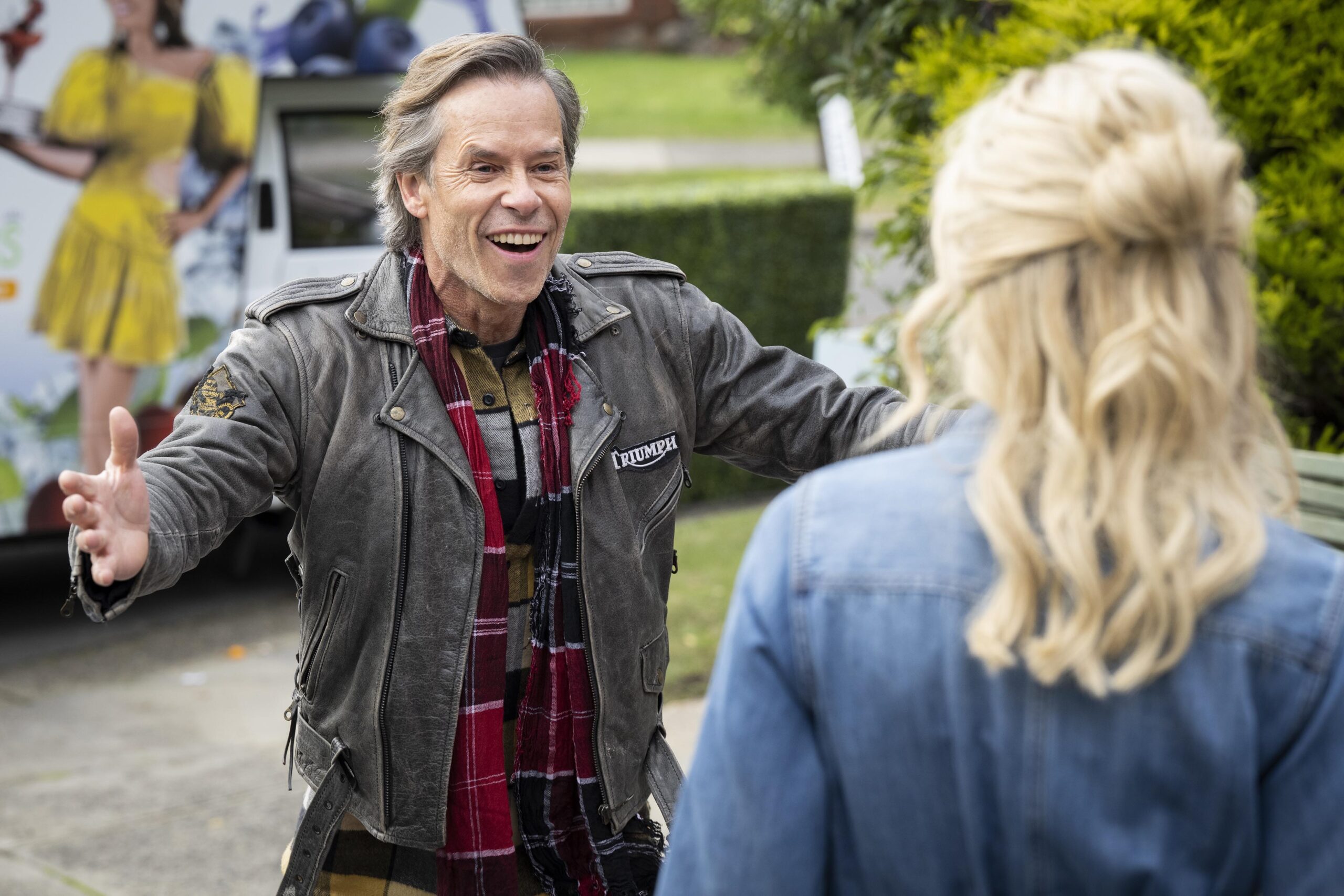 Mike Young beams with his arms wide as he returns to Ramsay Street