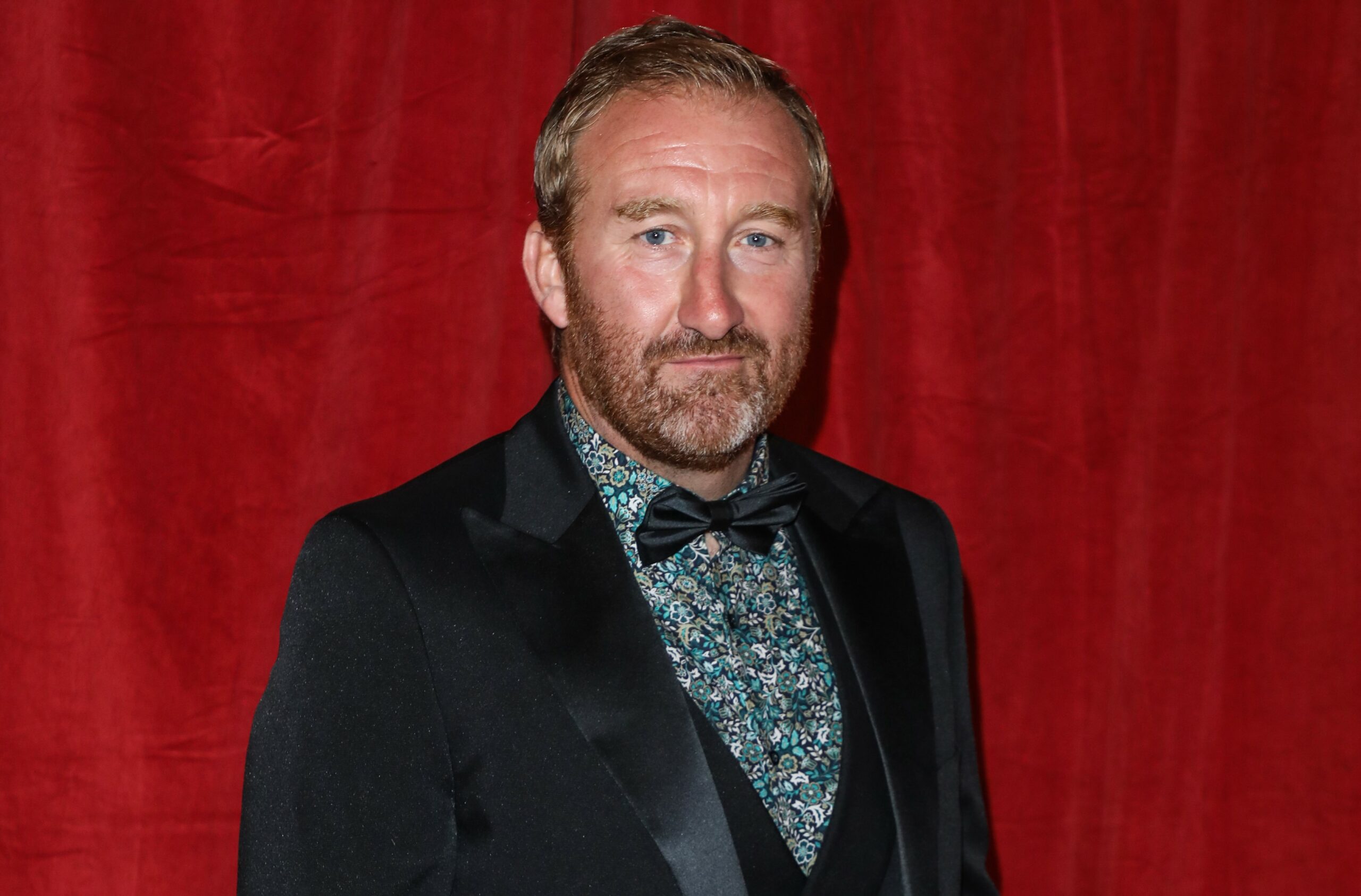 Jamie Kenna smiles on the red carpet at the 2022 British Soap Awards