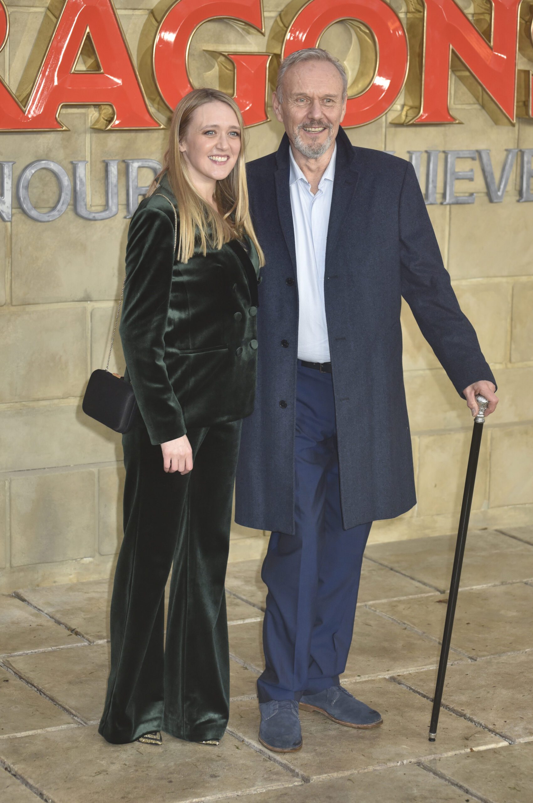 Emily Head and her dad Anthony smile on red carpet at movie premiere