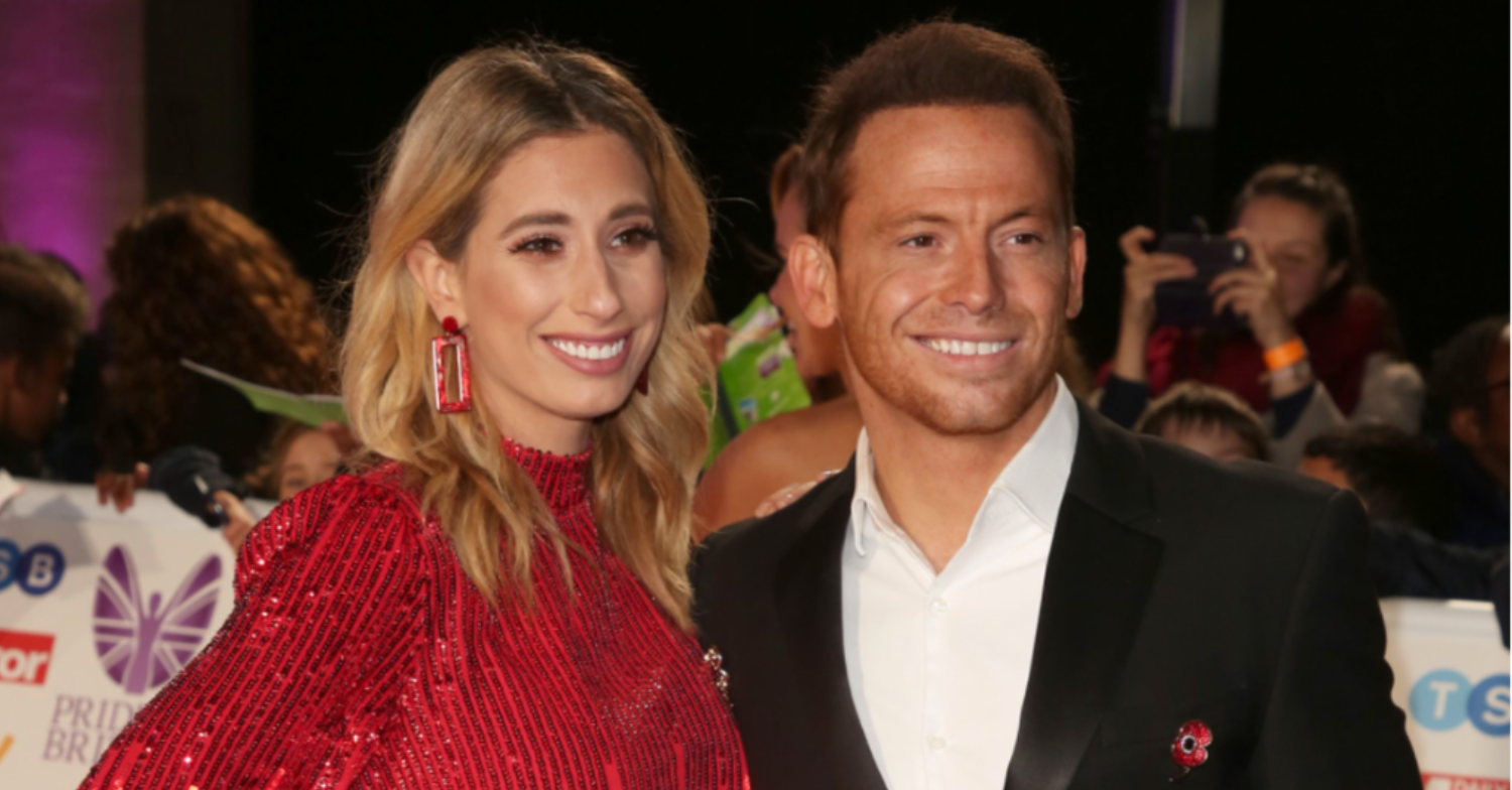 Stacey and Joe pose for photos in front of a crowd