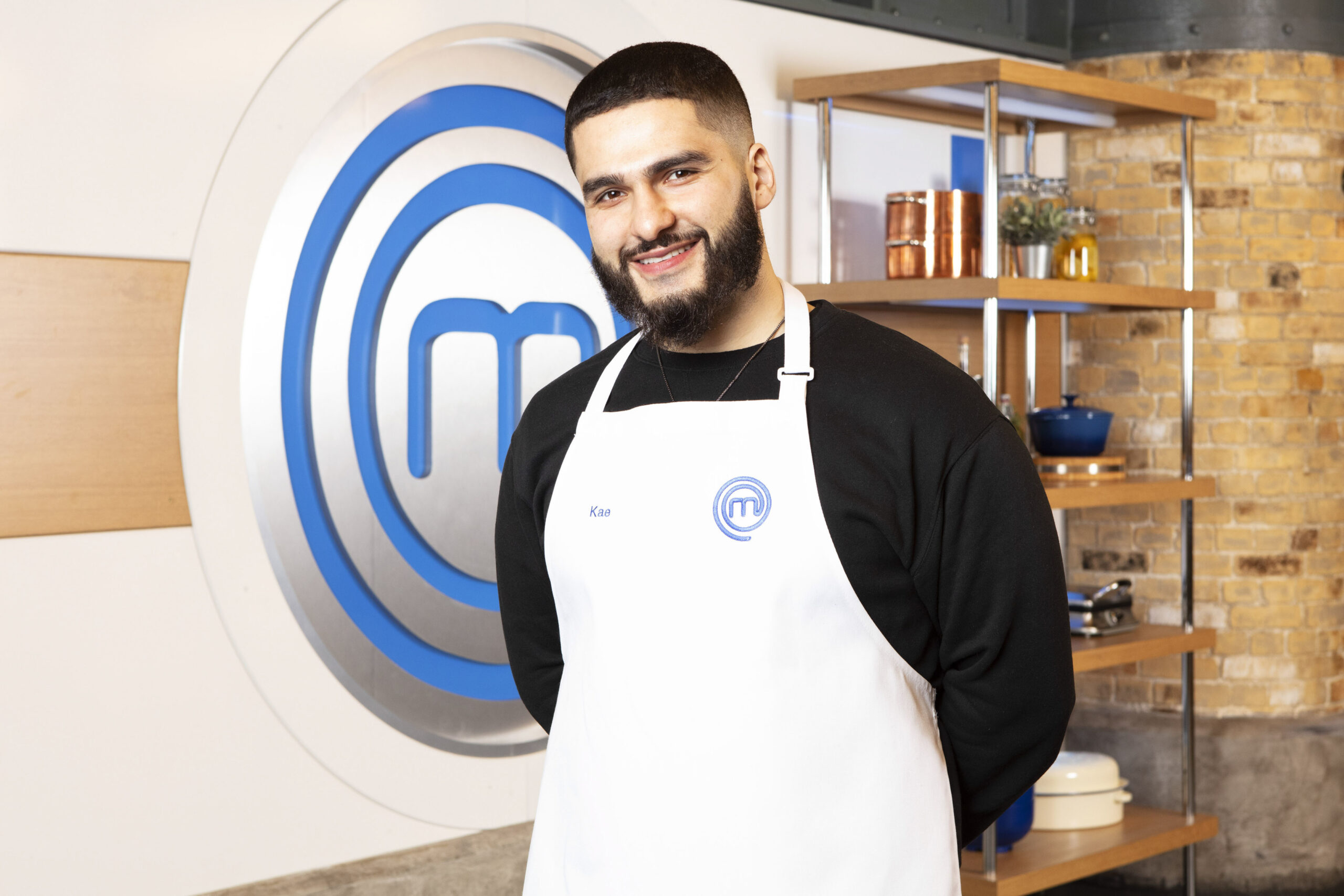Kae Kurd smiles in his masterchef apron
