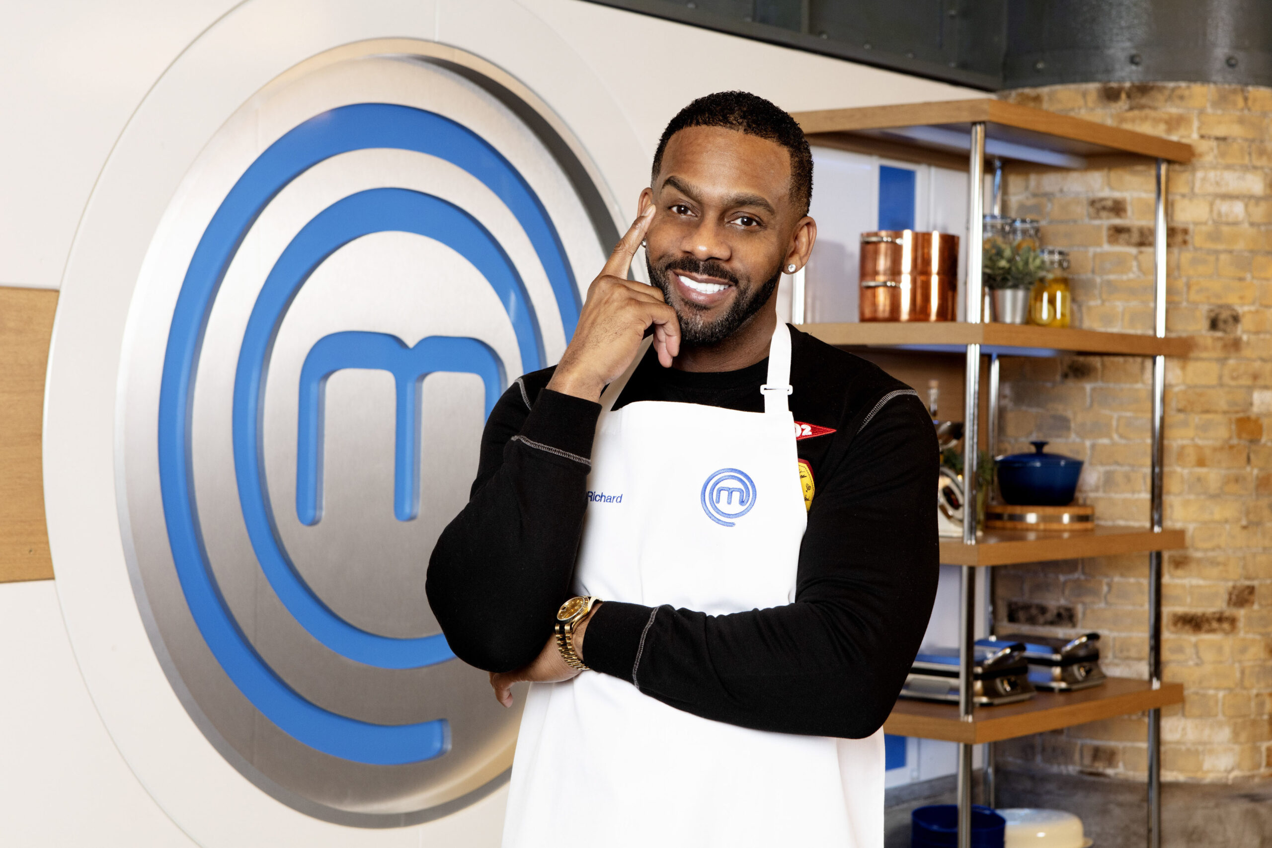 Richard Blackwood poses in his masterchef apron