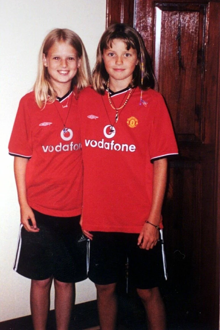 Holly Wells and Jessica Chapman smile in Man-UTD tops