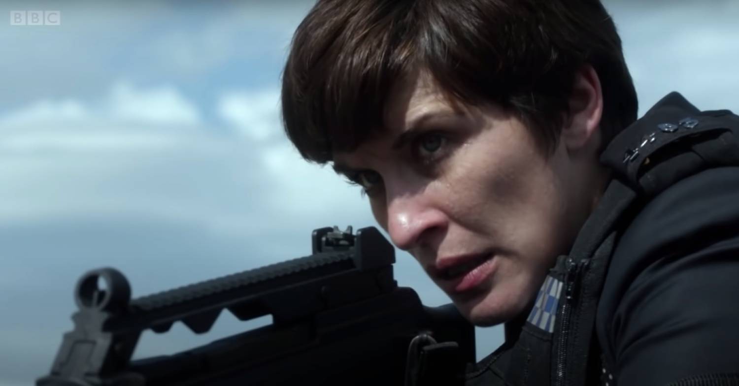 Vicky McClure as DI Kate Fleming hold a gun