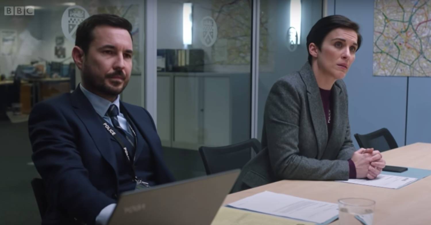 Martin Compston as DI Steve Arnott sits next to Vicky McClure as DI Kate Fleming
