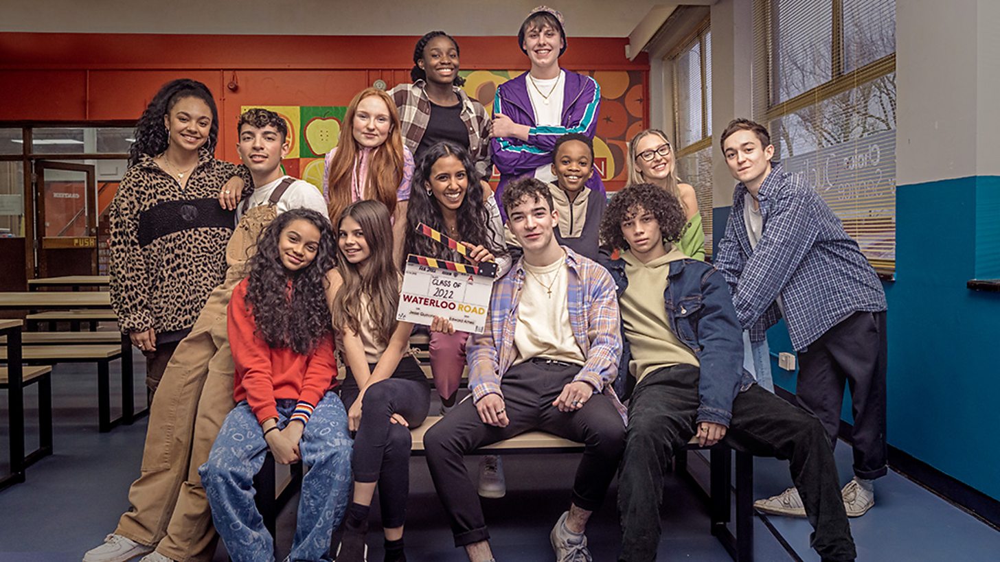 The cast of Waterloo Road 2023 smiling behind the scenes 