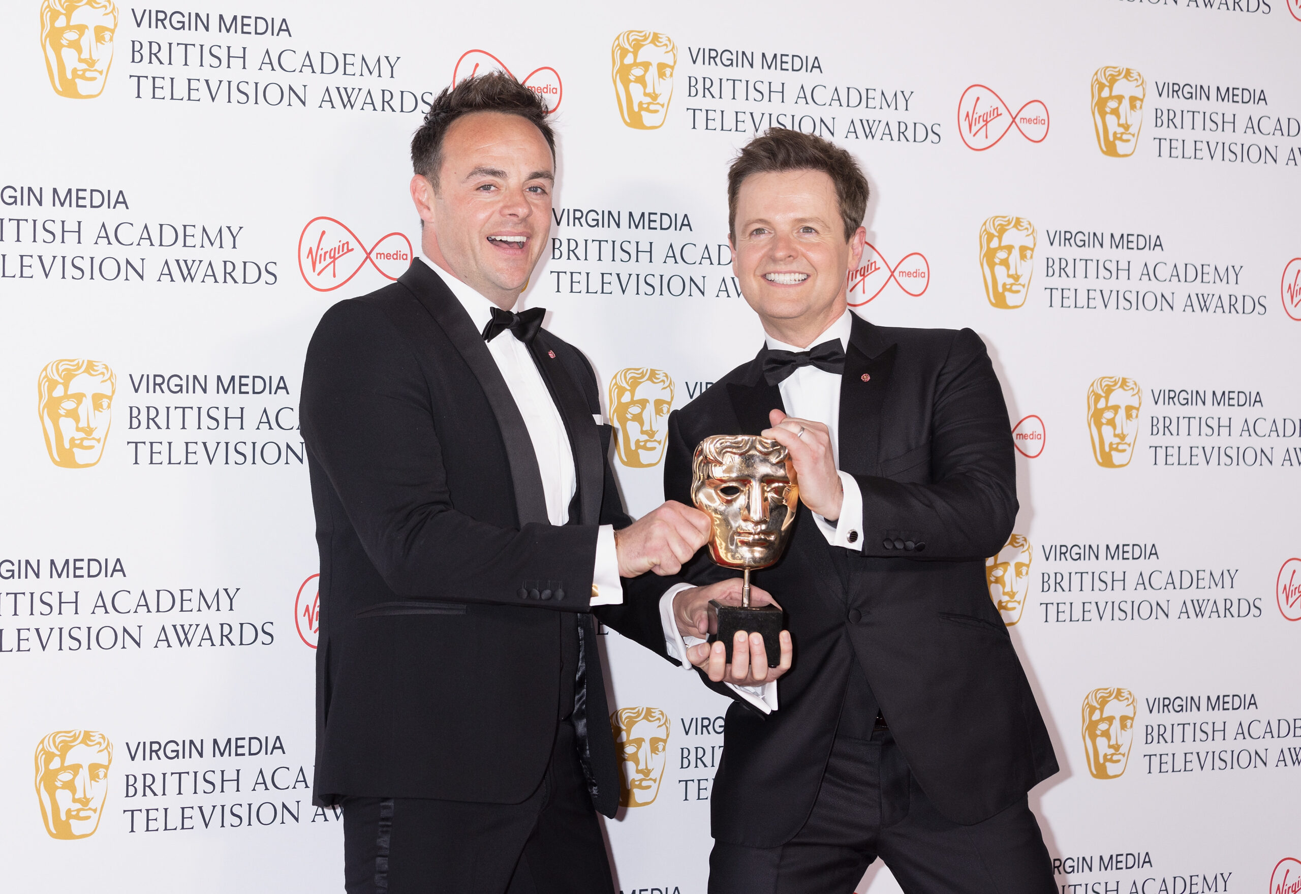 Ant McPartlin and Dec Donnelly smile at the BAFTAs with award