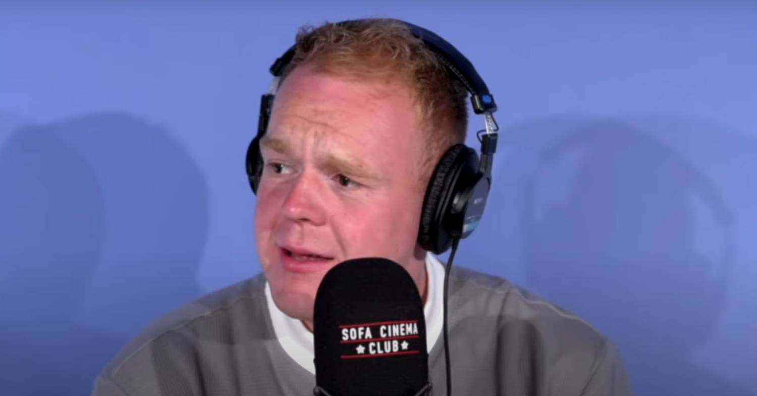 Colson Smith speaks into a microphone for his podcast