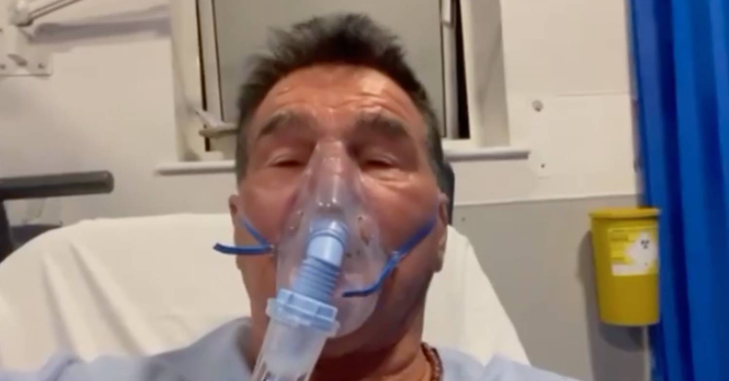Paddy Doherty wears an oxygen mask in a hospital bed