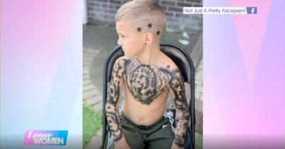 A young boy is pictured with temporary tattooed sleeves.