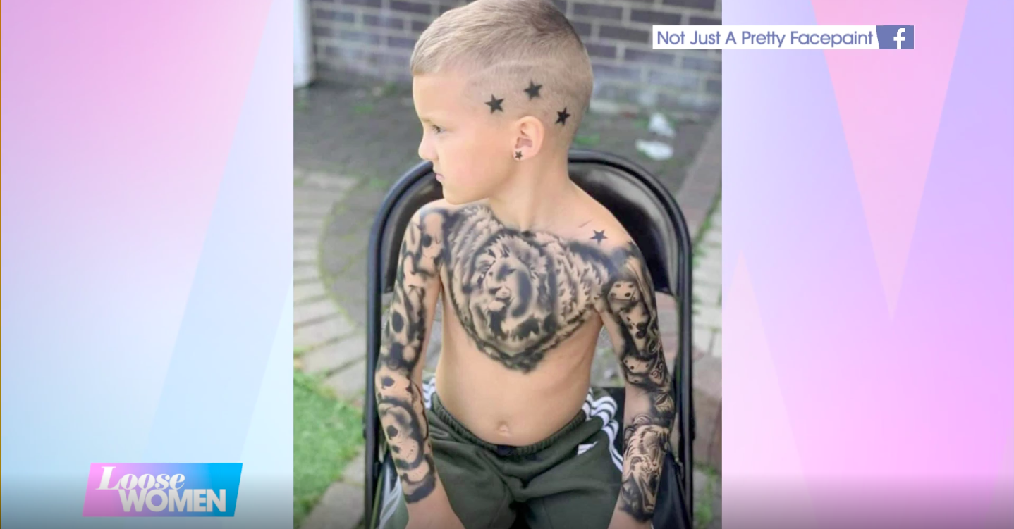 A young boy is pictured with temporary tattooed sleeves. 