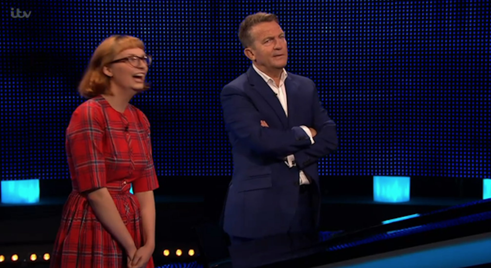 Contestant wearing red with Bradley Walsh on The Chase