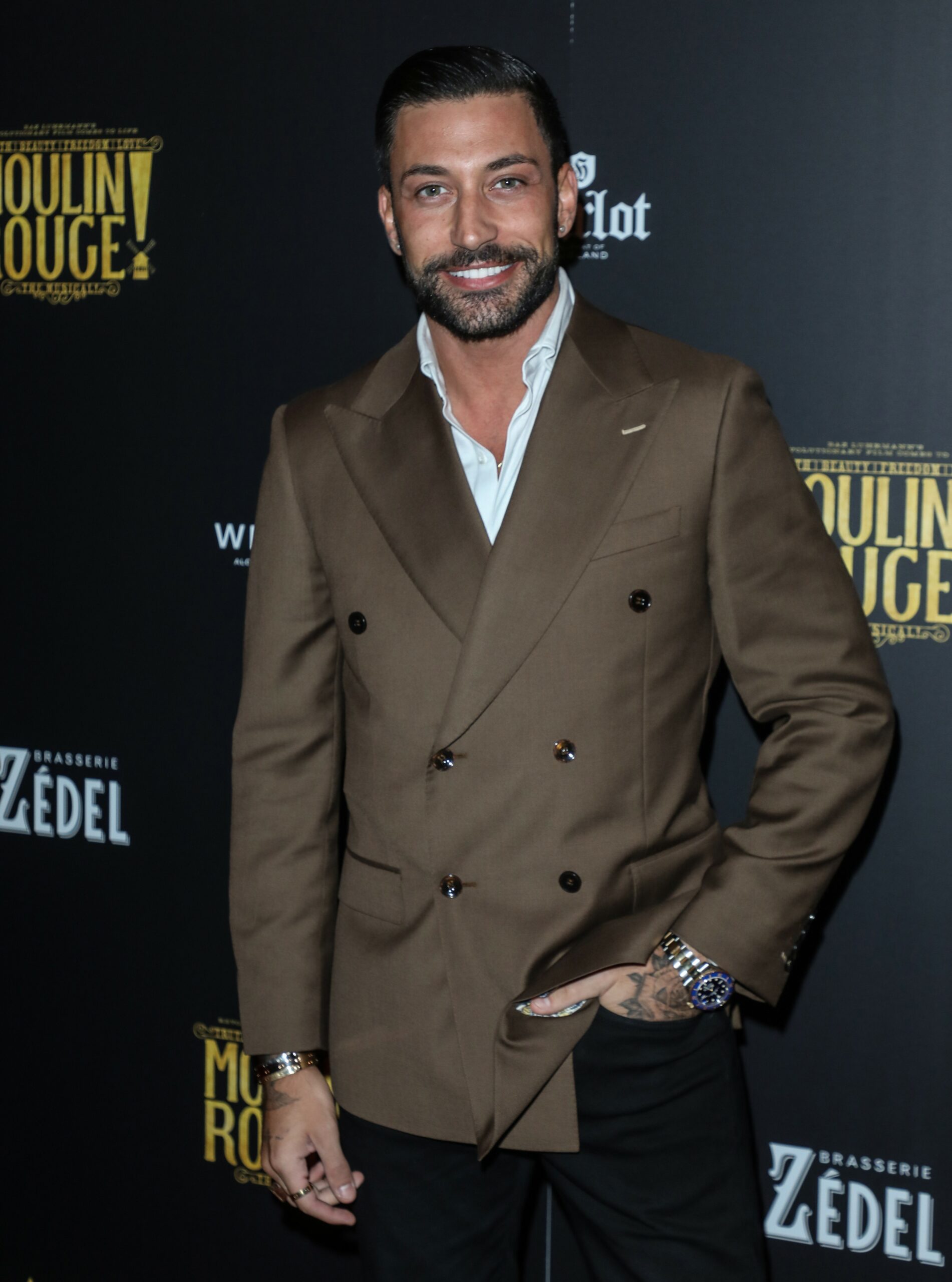 Strictly star Giovanni Pernice smiling with hand in his pocket at event