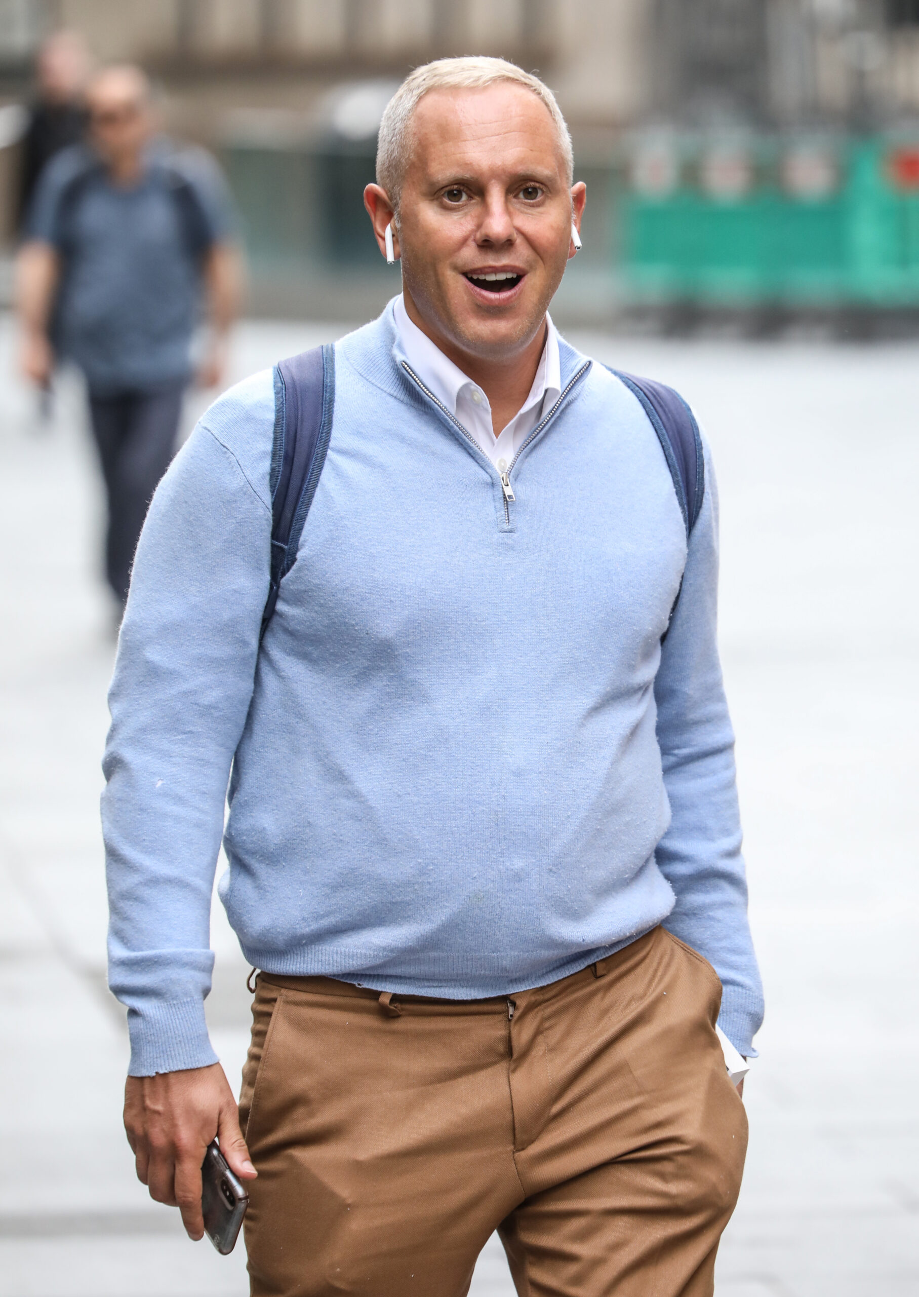 Judge Rinder walks in London with a blue jumper on, looking heavier than the shredded picture on his Instagram.