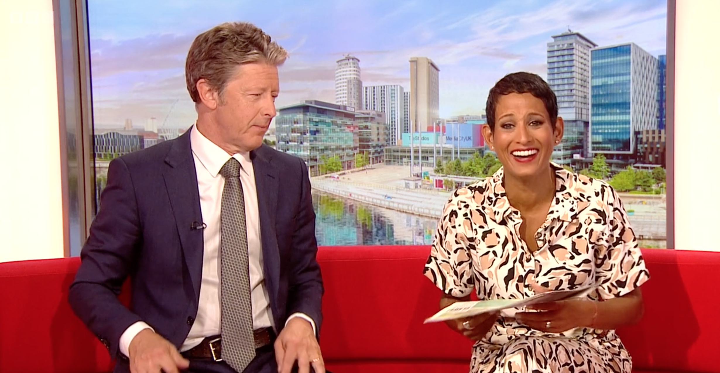 Charlie Stayt looking Stern with Naga laughing BBC Breakfast