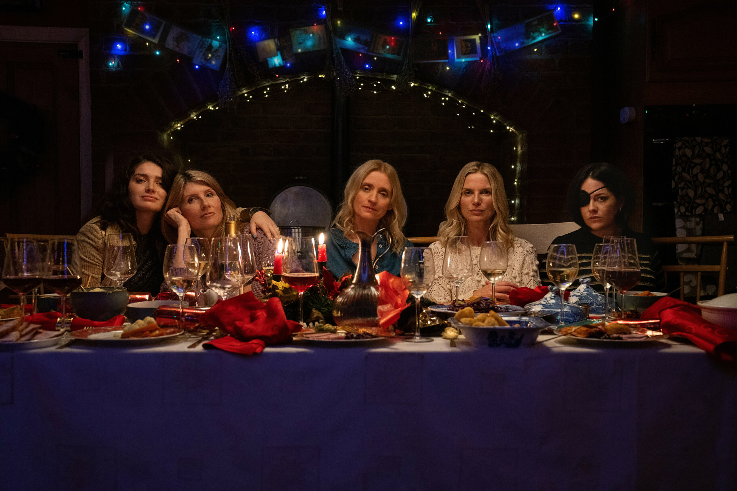 The cast of Bad Sisters on Apple TV in a promotional photo, they sit around a table
