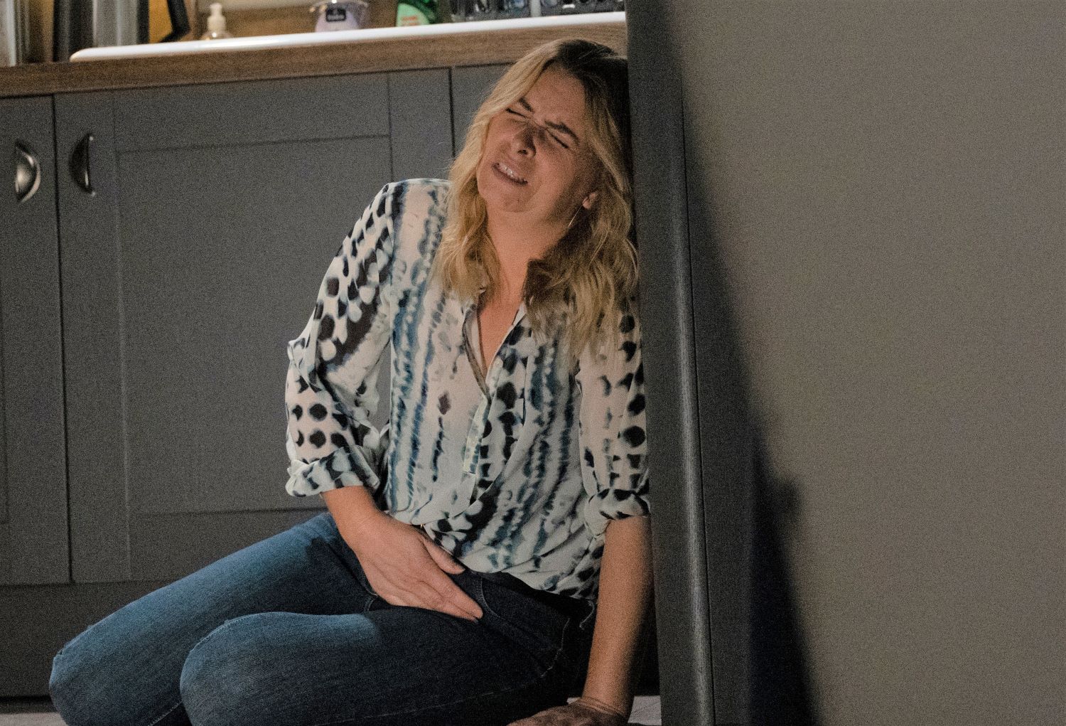 Charity clutches her stomach in pain Emmerdale 