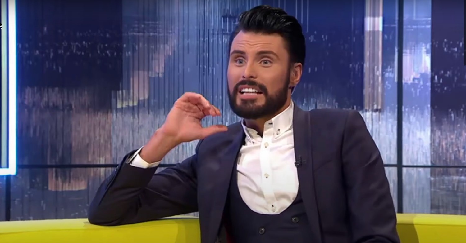 Rylan Clark in a three-piece suit looking surprised on Big Brother Bit on the Side 