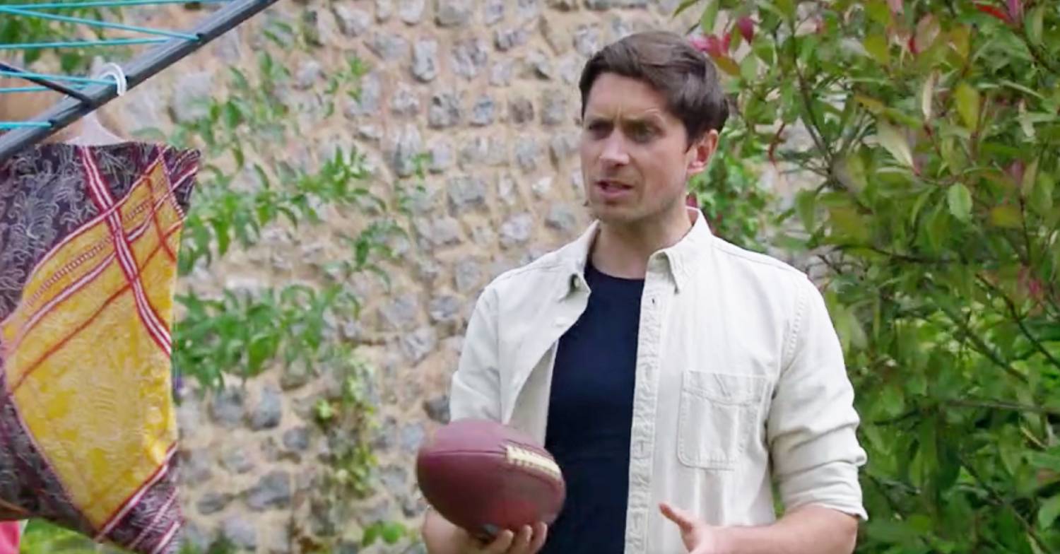 Thoren Ferguson holds a ball as Kit in Emmerdale