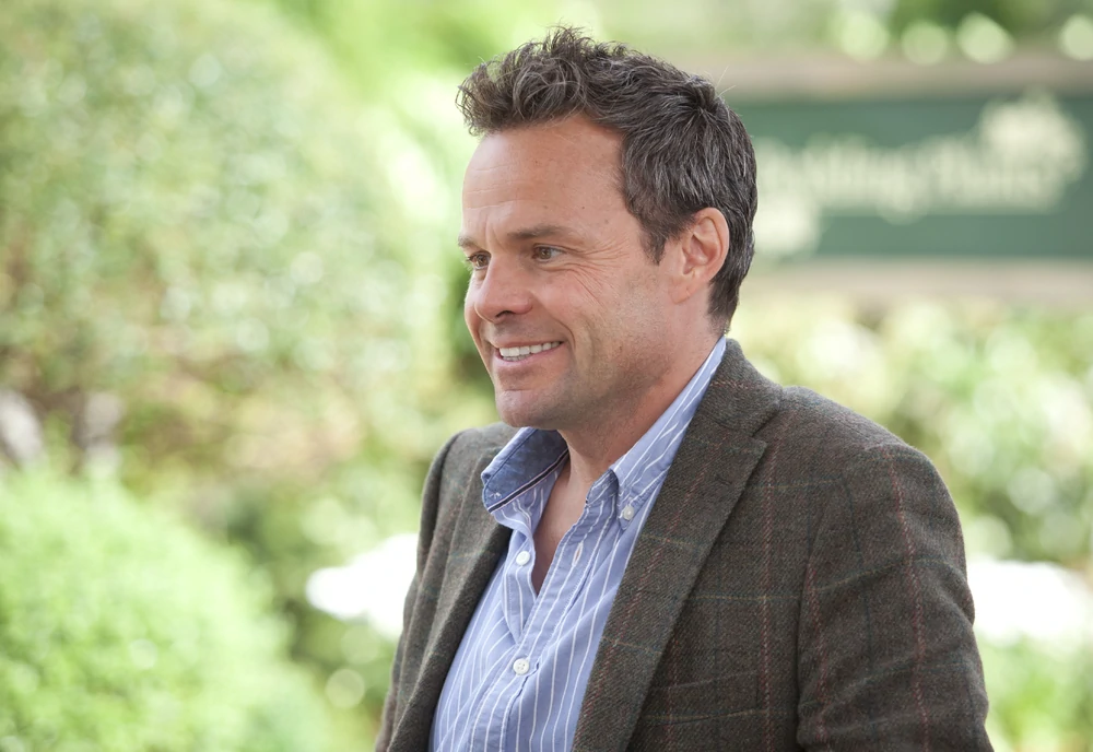Jamie Glover smiles as James Lacey in Agatha Raisin and the Walkers of Dembley