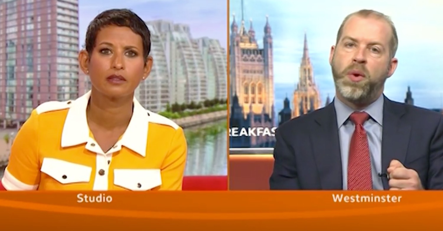 Naga Munchetty in orange dress interviewing labour MP on BBC Breakfast