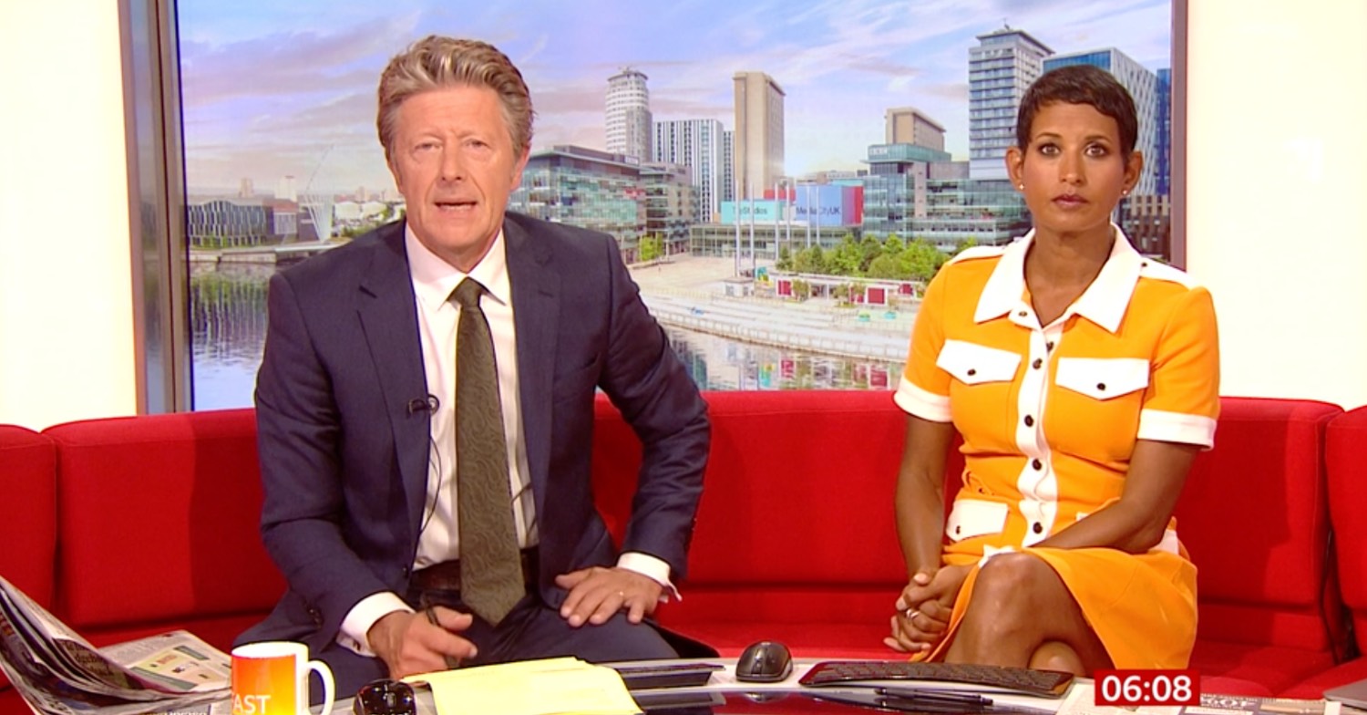 Naga Munchetty in orange dress alongside Charlie Stayt on BBC Breakfast