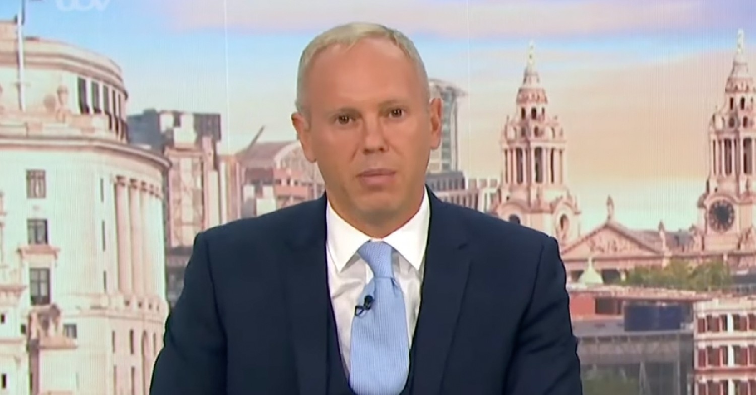 Rob Rinder hosting GMB today in a navy suit 