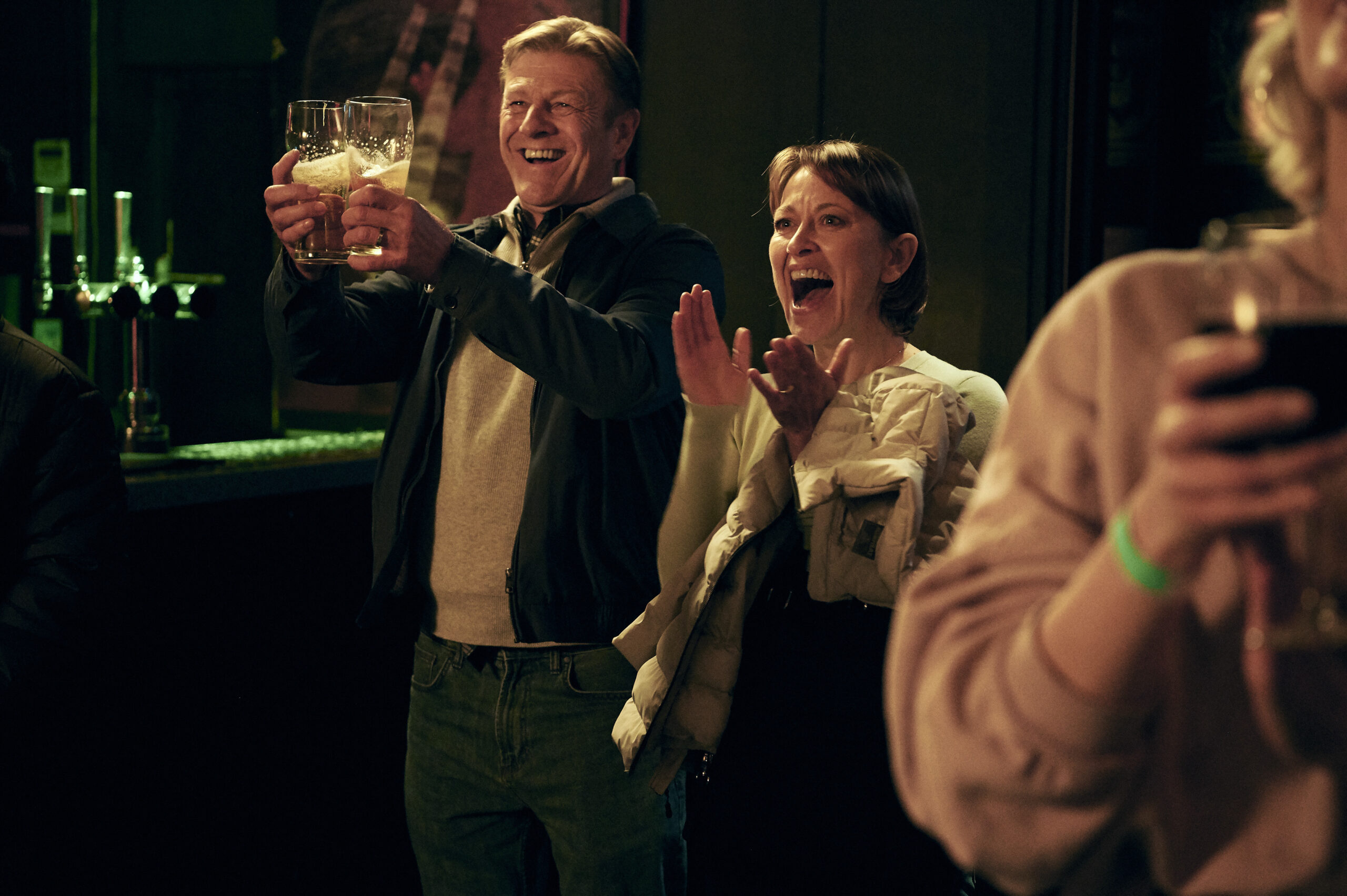 Sean Bean as Ian (Left) and Nicola Walker as Emma (Right) they celebrate and clap in Marriage on BBC One