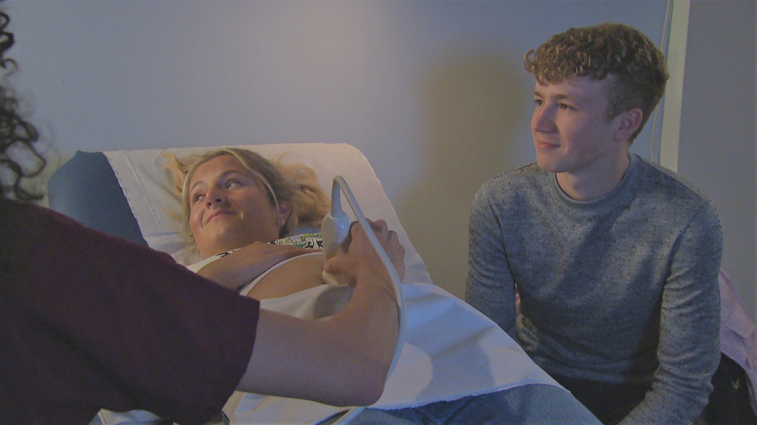 Amelia at her baby scan with Noah, both looking at the image on the screen