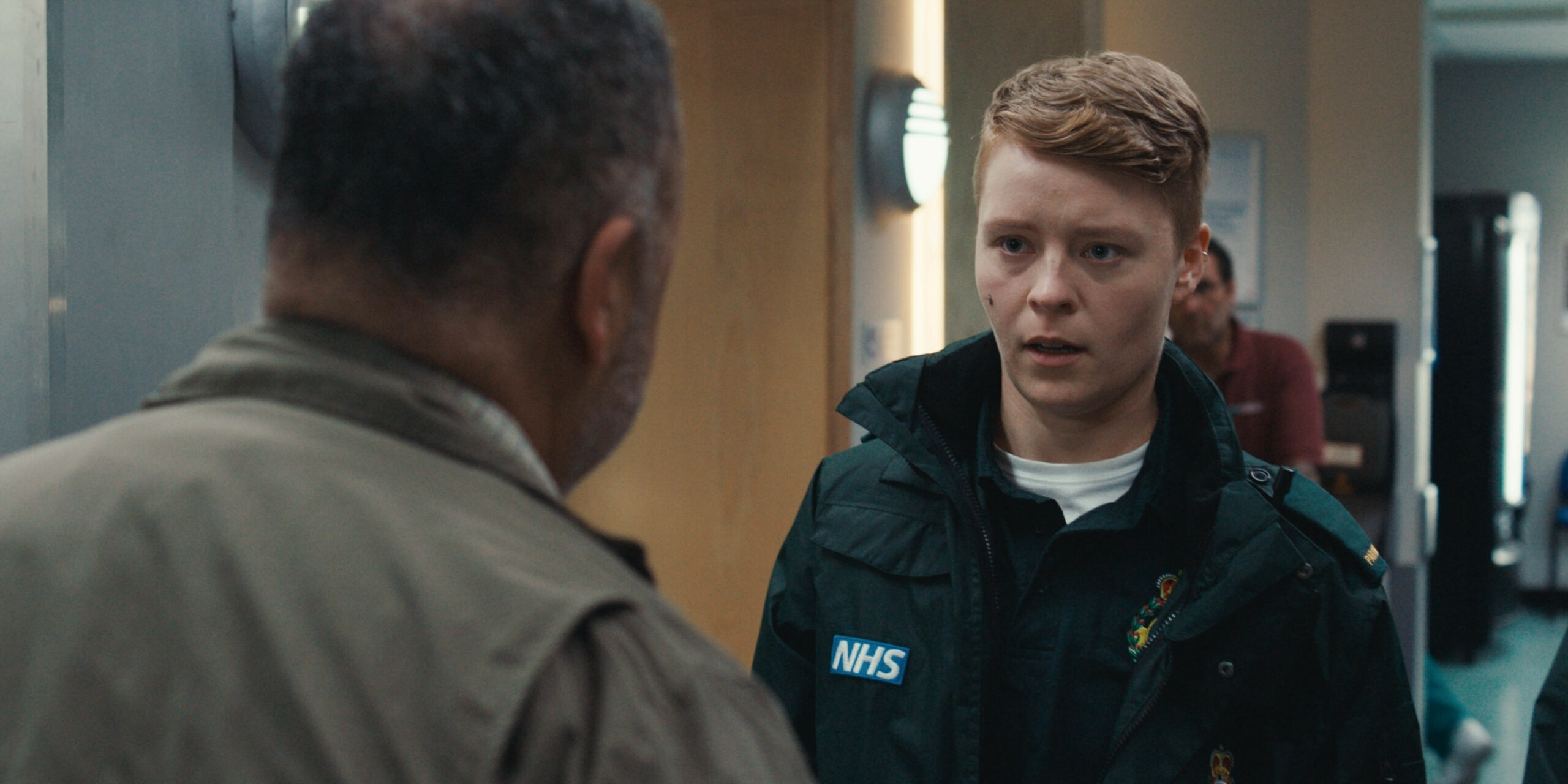 Sah has a cut on their face as they are confronted by an angry parent