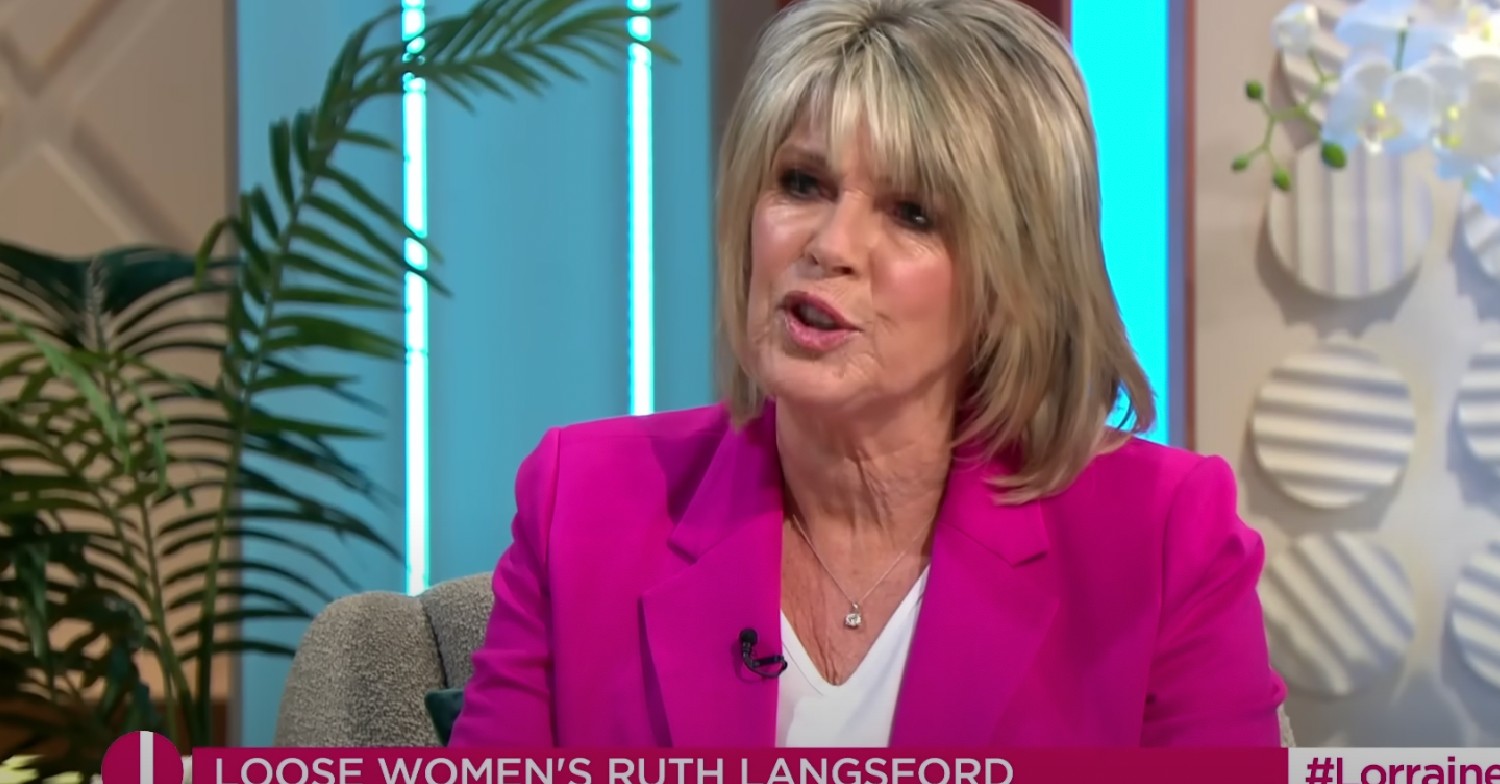 Ruth Langsford talking while wearing a fuscia jacket and white top