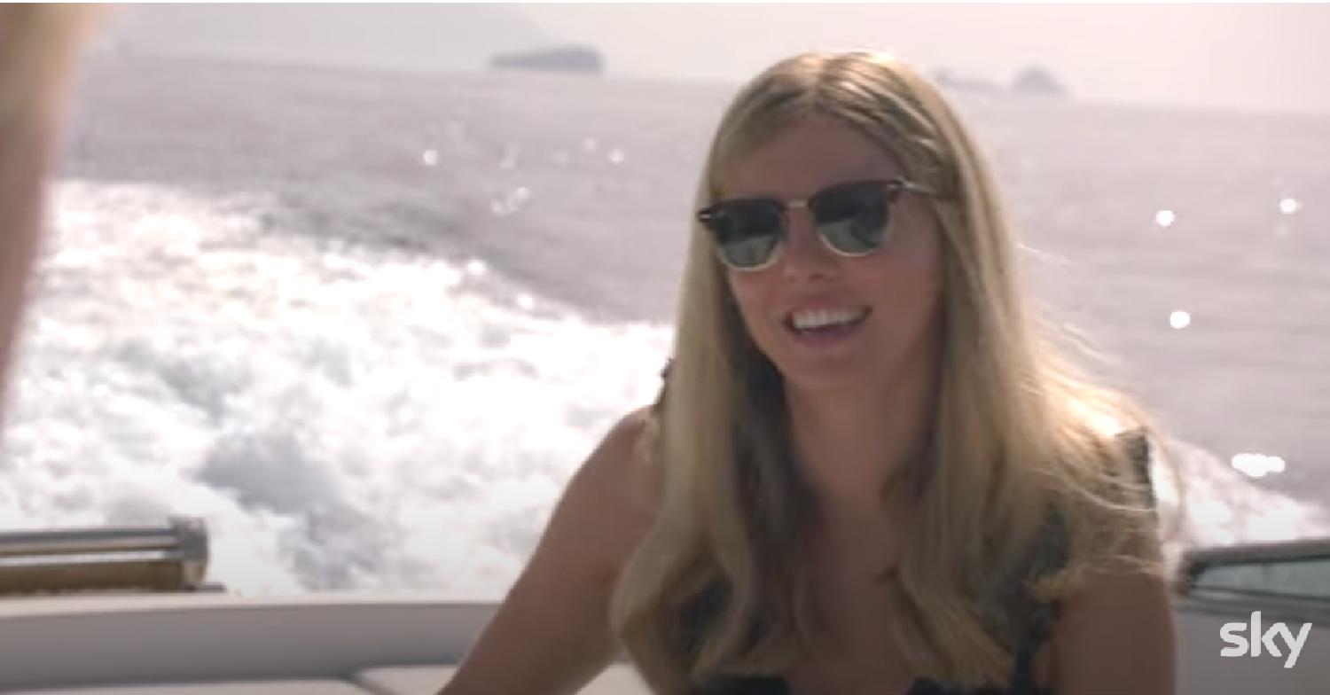 Ophelia Lovibond as Carrie Johnson in a boat with waves behind her