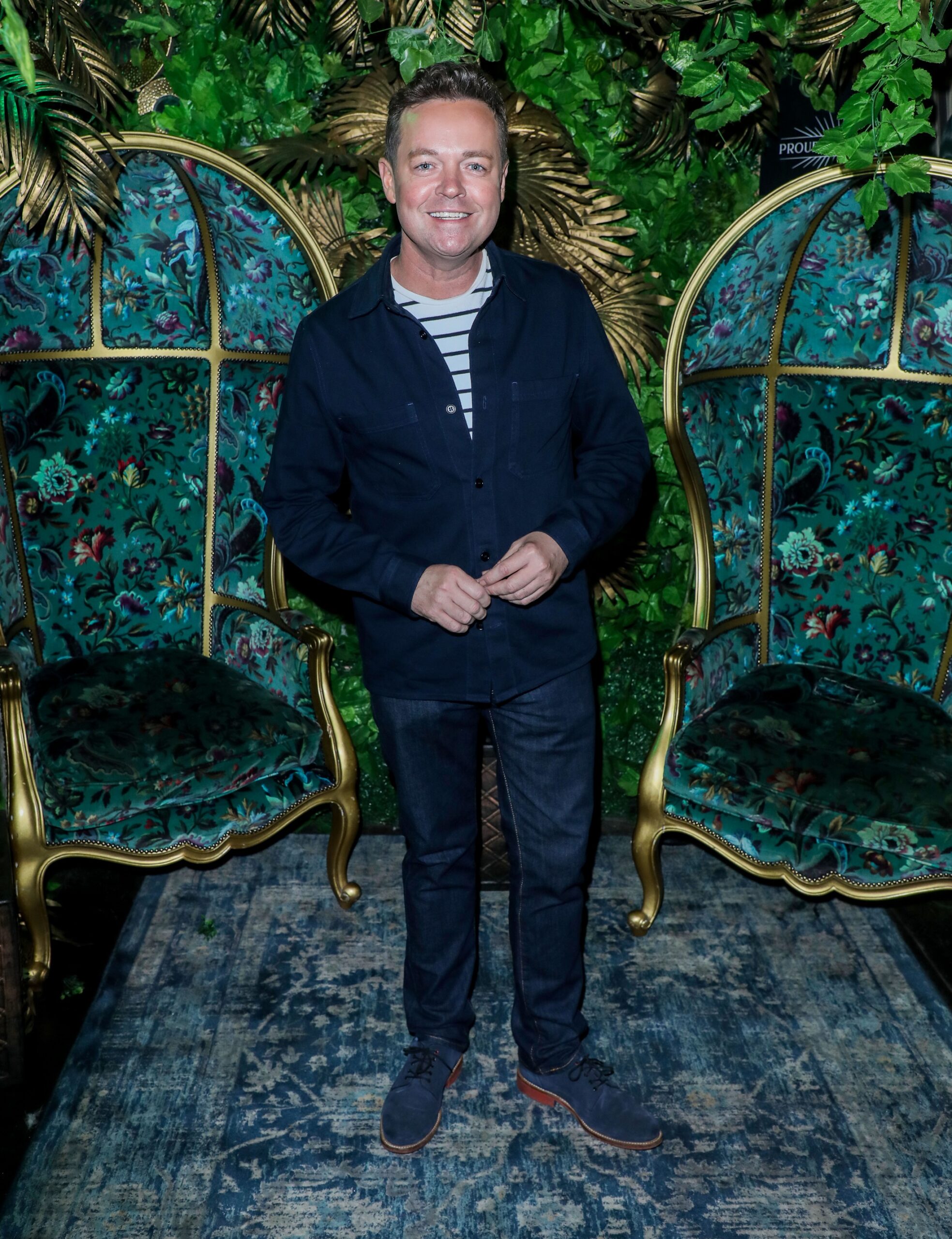 Stephen Mulhern smiling on the red carpet in a navy outfit