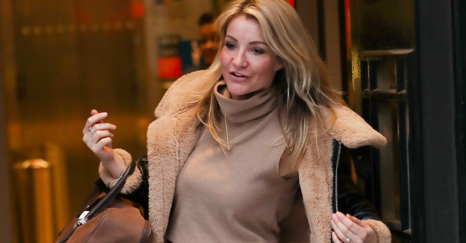Helen Skelton leaving a building in a coat and carrying a bag