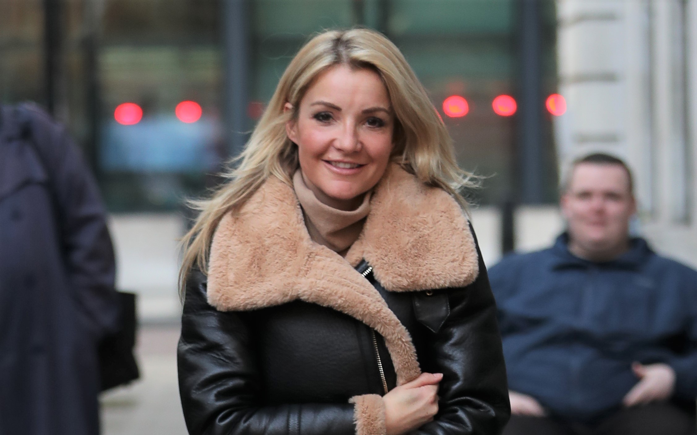 Helen Skelton smiles in warm leather jacket with her hair down