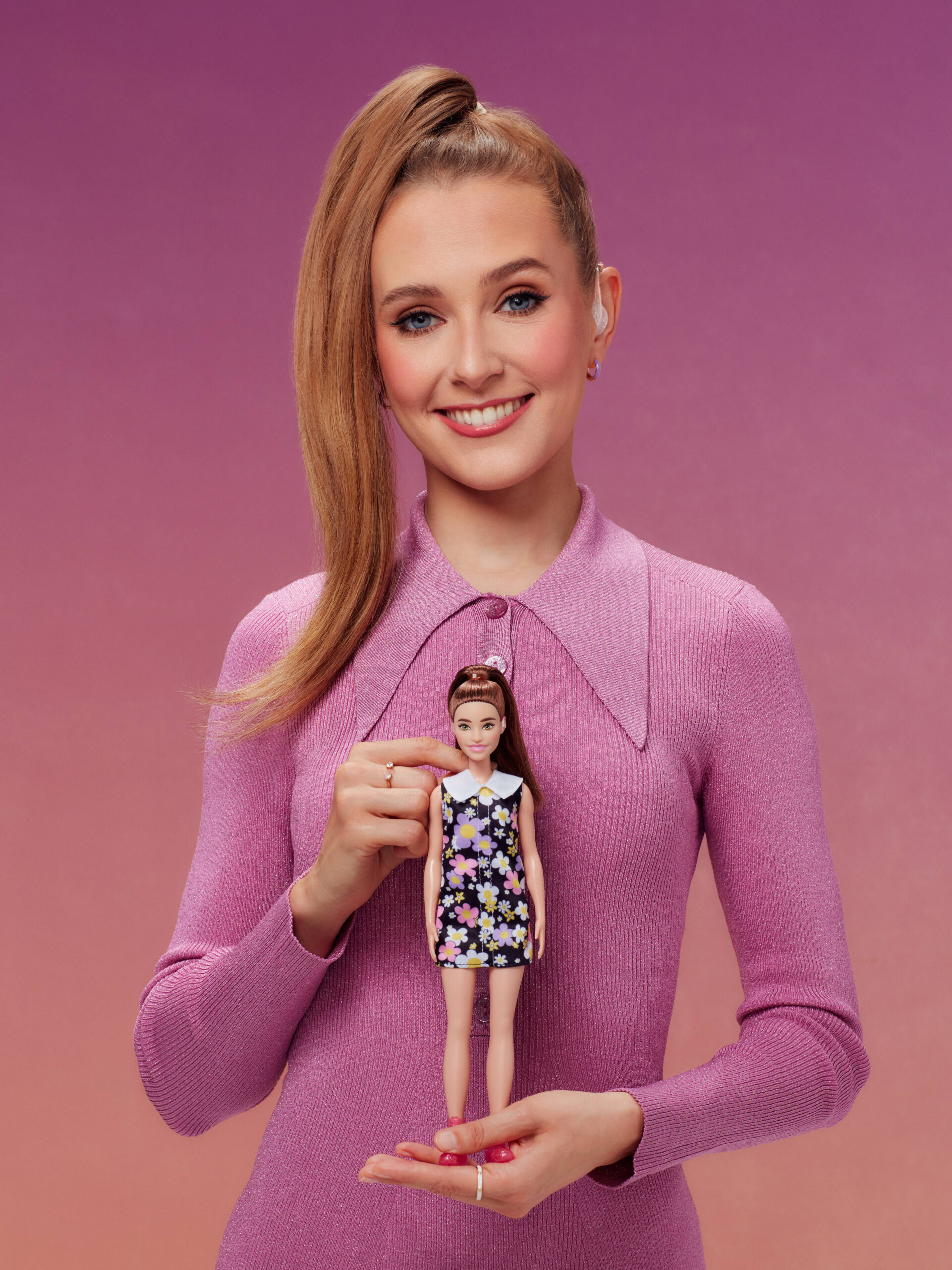 Rose Ayling-Ellis smiling while holding a Barbie doll