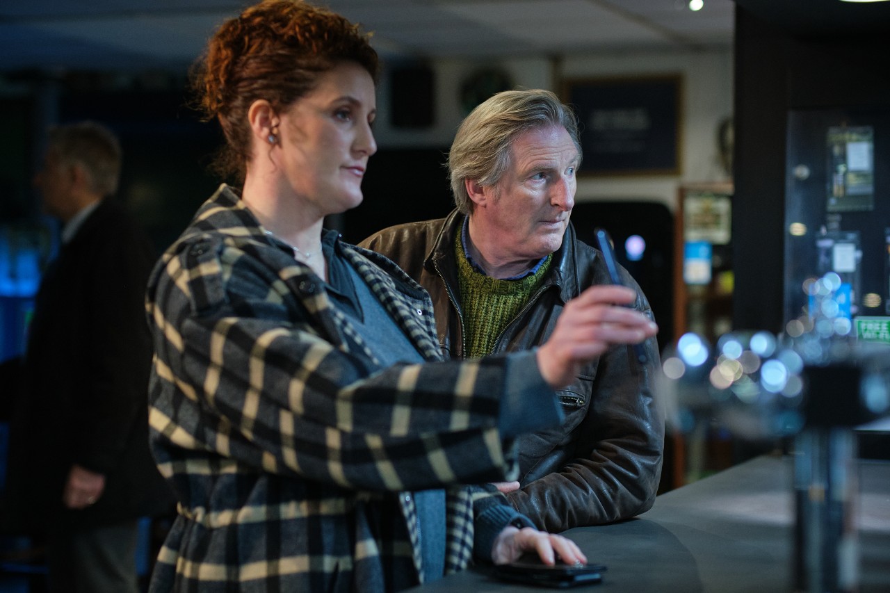 ADRIAN DUNBAR AS RIDLEY AND BRONAGH WAUGH AS CAROL FARHAM IN RIDLEY S1E2