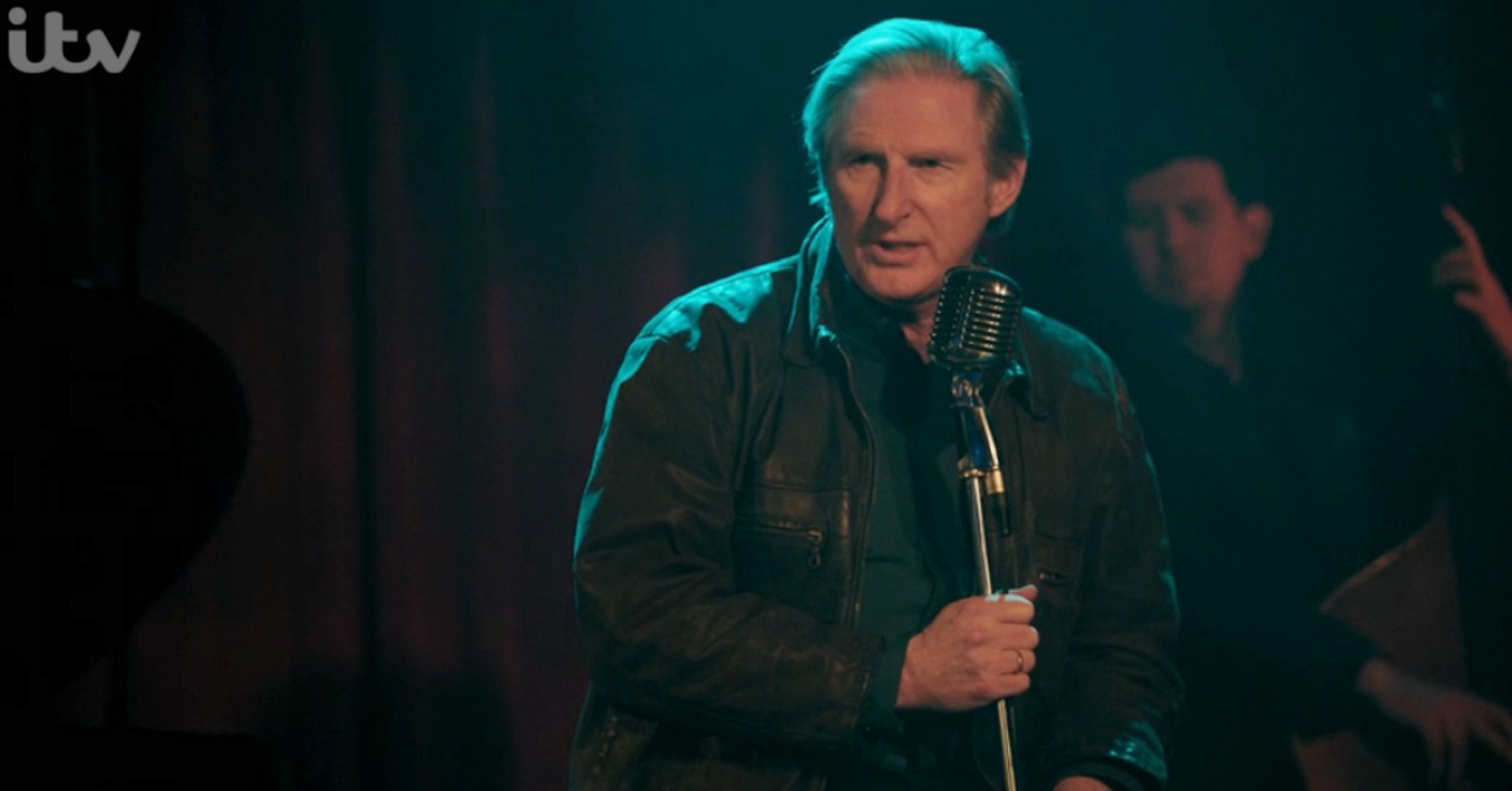 Adrian Dunbar as ex Inspector Detective Ridley singing in drama