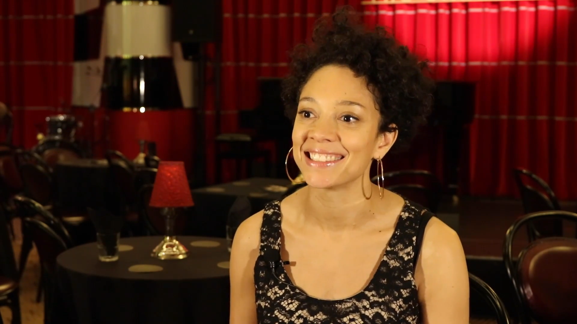 Camilla Beeput smiling in an interview at a cabaret bar