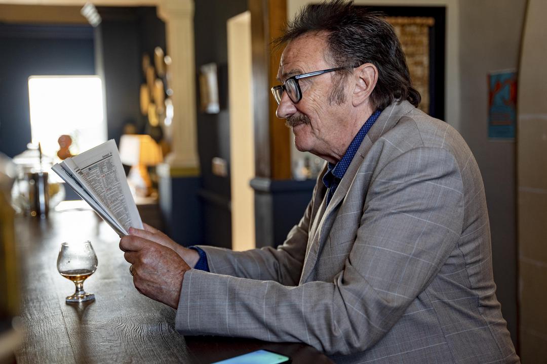 Paul Chuckle reading the newspaper as Trevor in the Madame Blanc Mysteries