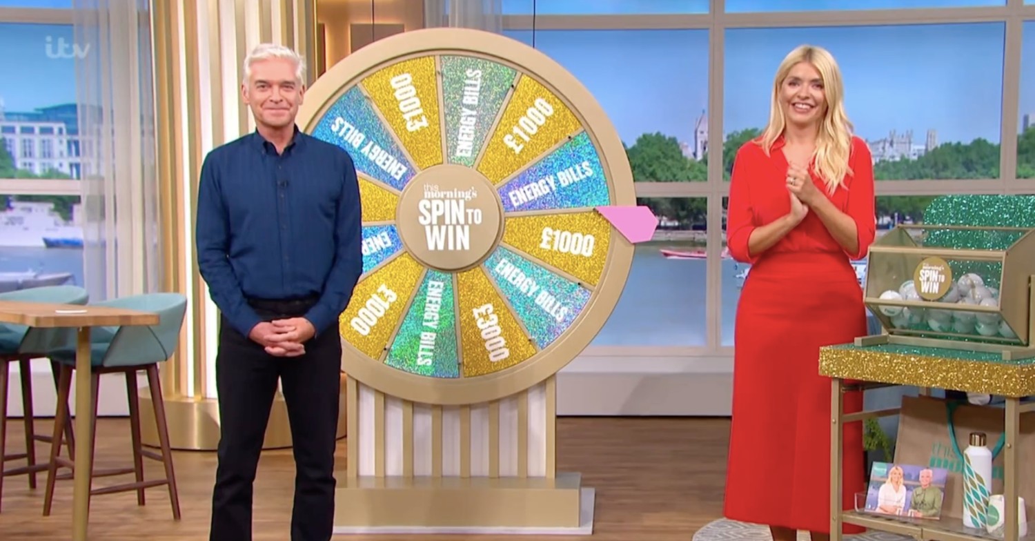 Holly and Phil standing next to the Spin to Win wheel on This Morning today