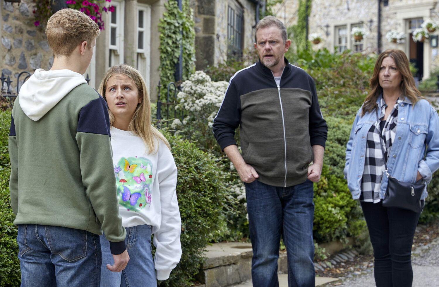 Dan, Amelia and Harriet looking at Noah in the village 