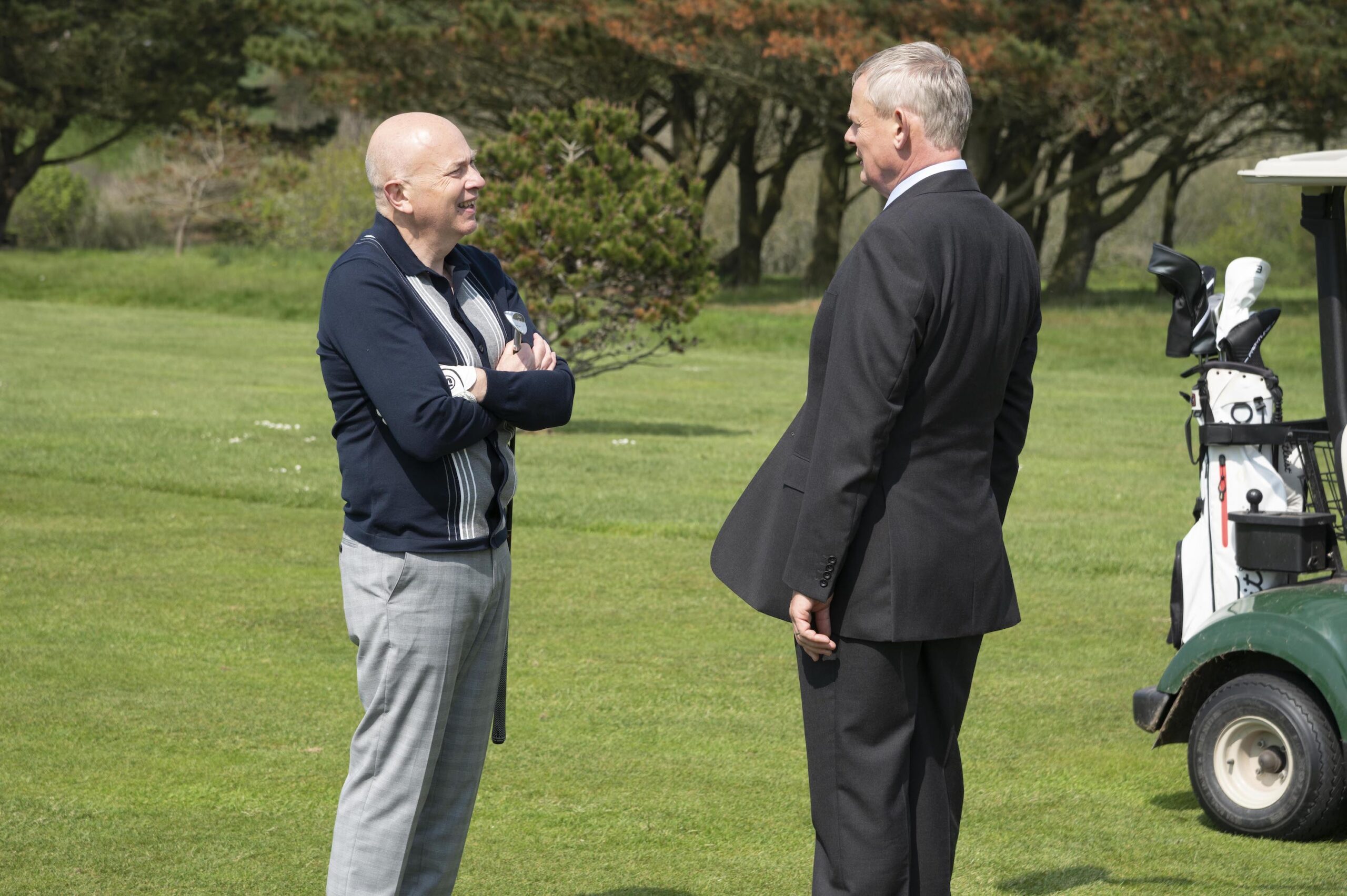 Chris Parsons and Doc Martin talking on a golf course