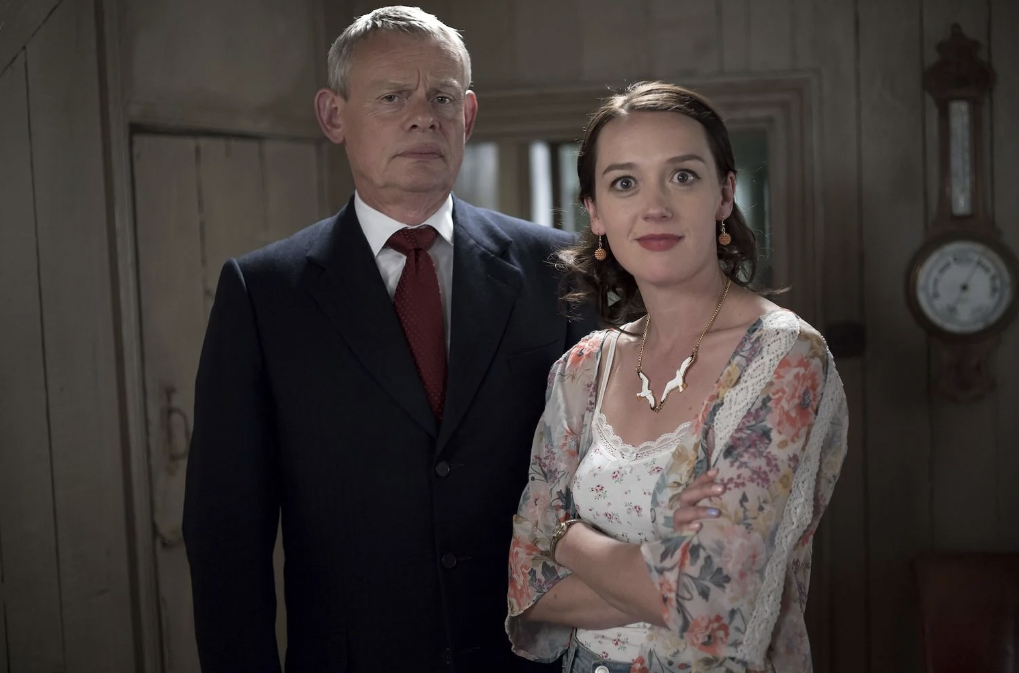 Doc Martin looking stern and Morwenna Newcross smiling