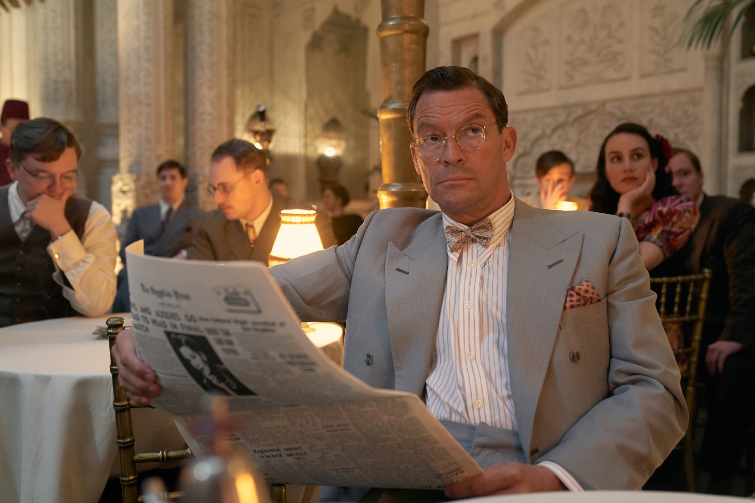 Dominic West in SAS Rogue Heroes as Dudley Clarke reading a newspaper