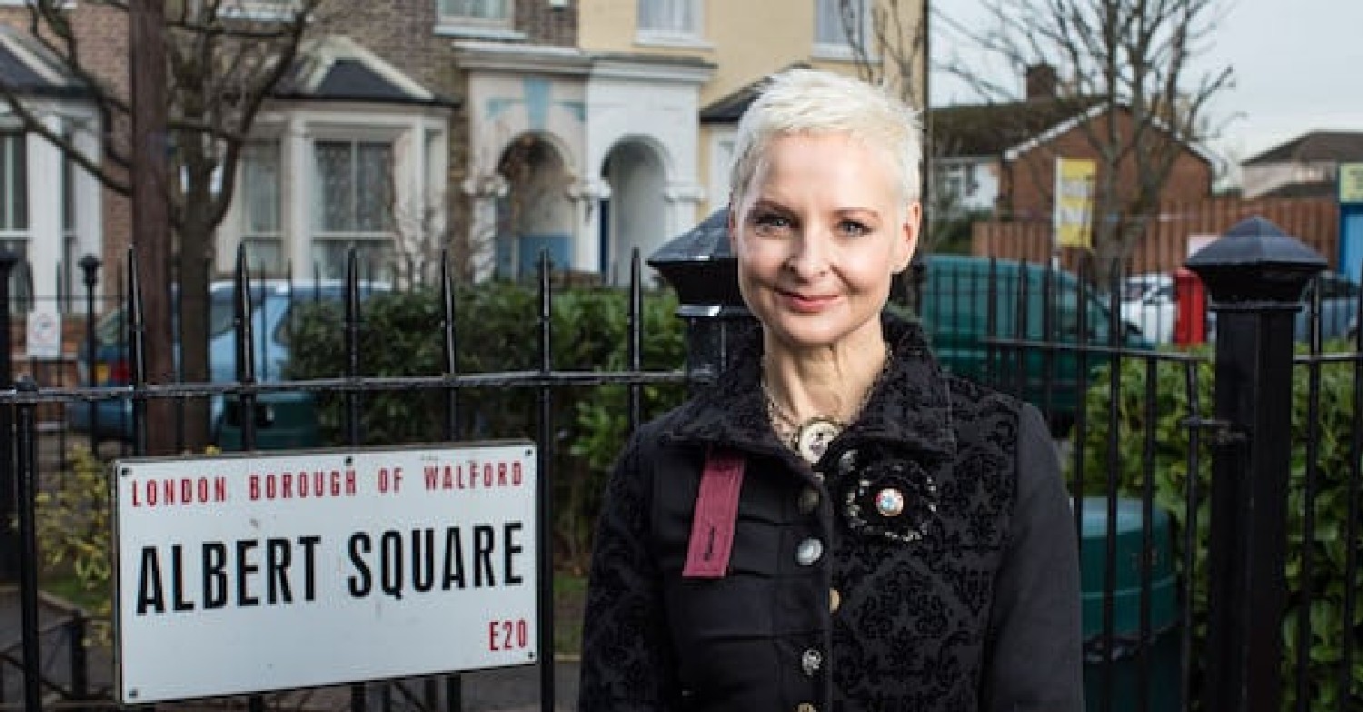 Mary Smith poses in front of the EastEnders sign for her return