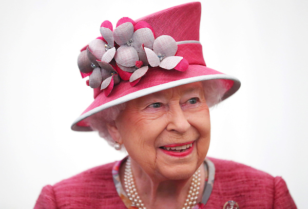The Queen smiles in pink hat