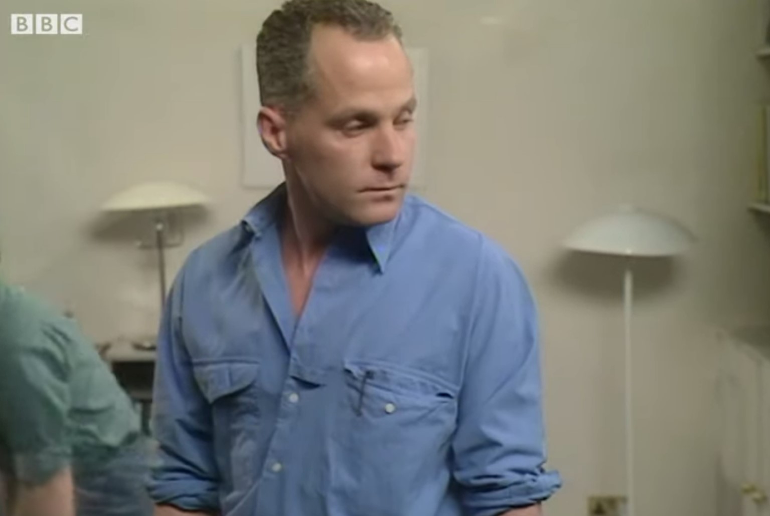 Colin Russell looks over his shoulder as he talks to Barry in EastEnders