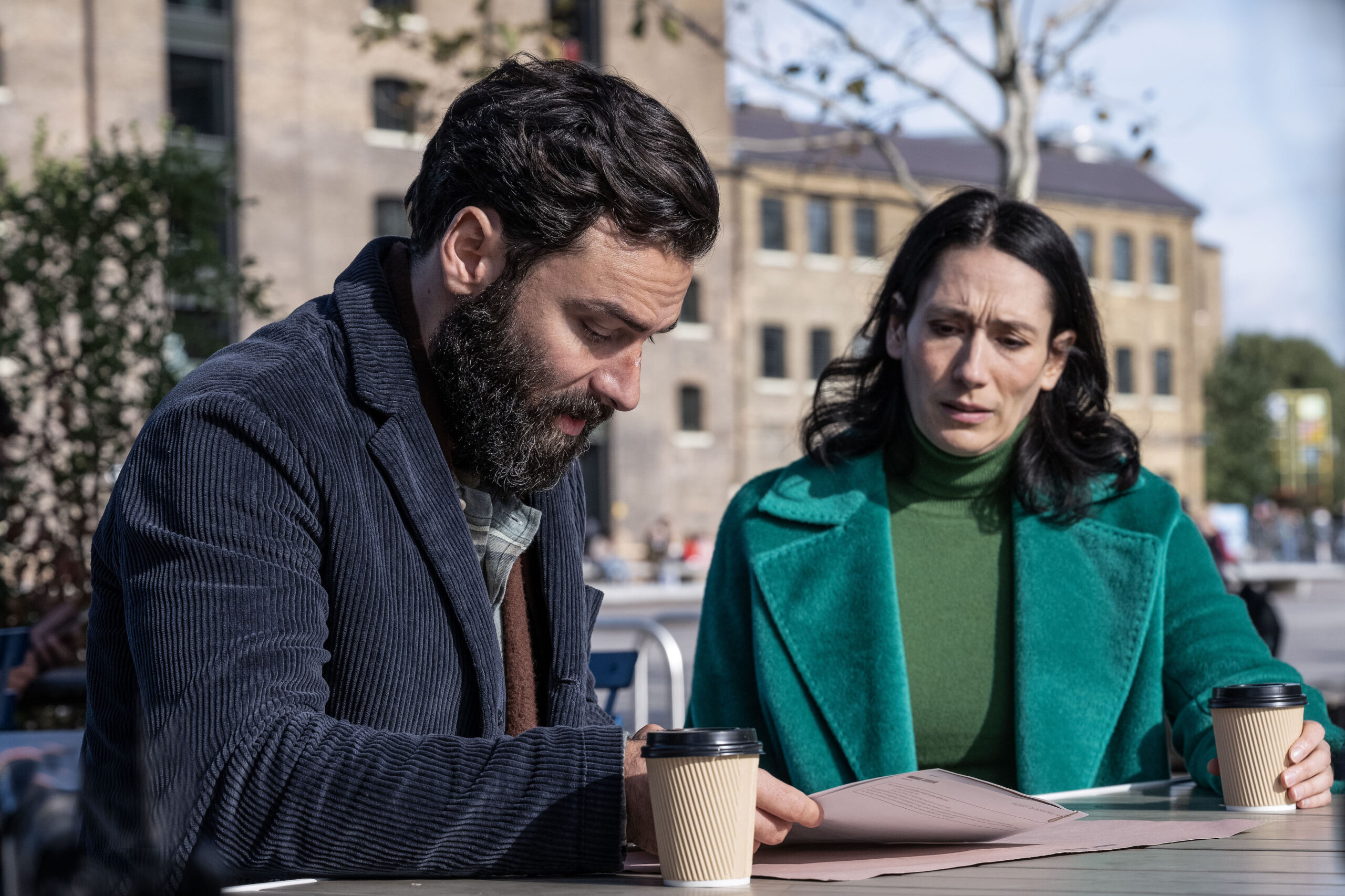 Aidan Turner reading case notes next to Sian Clifford