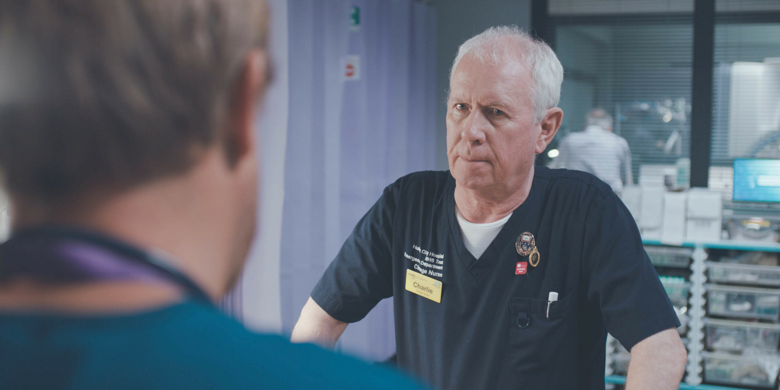 Charlie is looking at Dylan with concern in Casualty